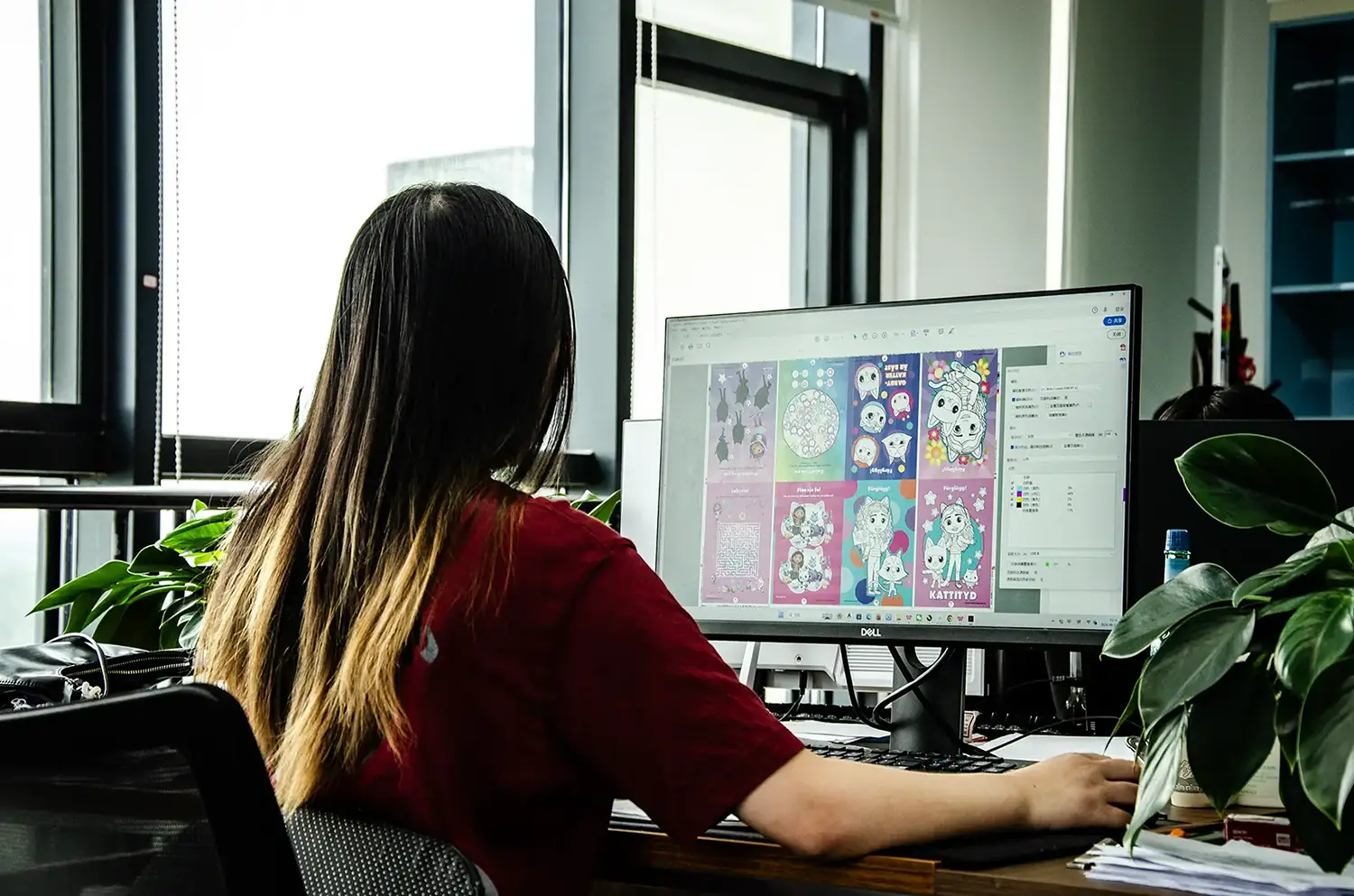 Xin An Printing operator reviewing a multi-page production layout on screen