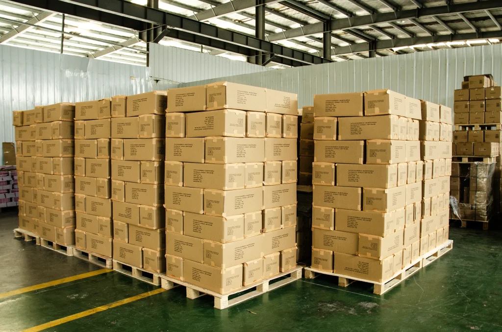 Historical shipment preparation, with cartons stacked on pallets.